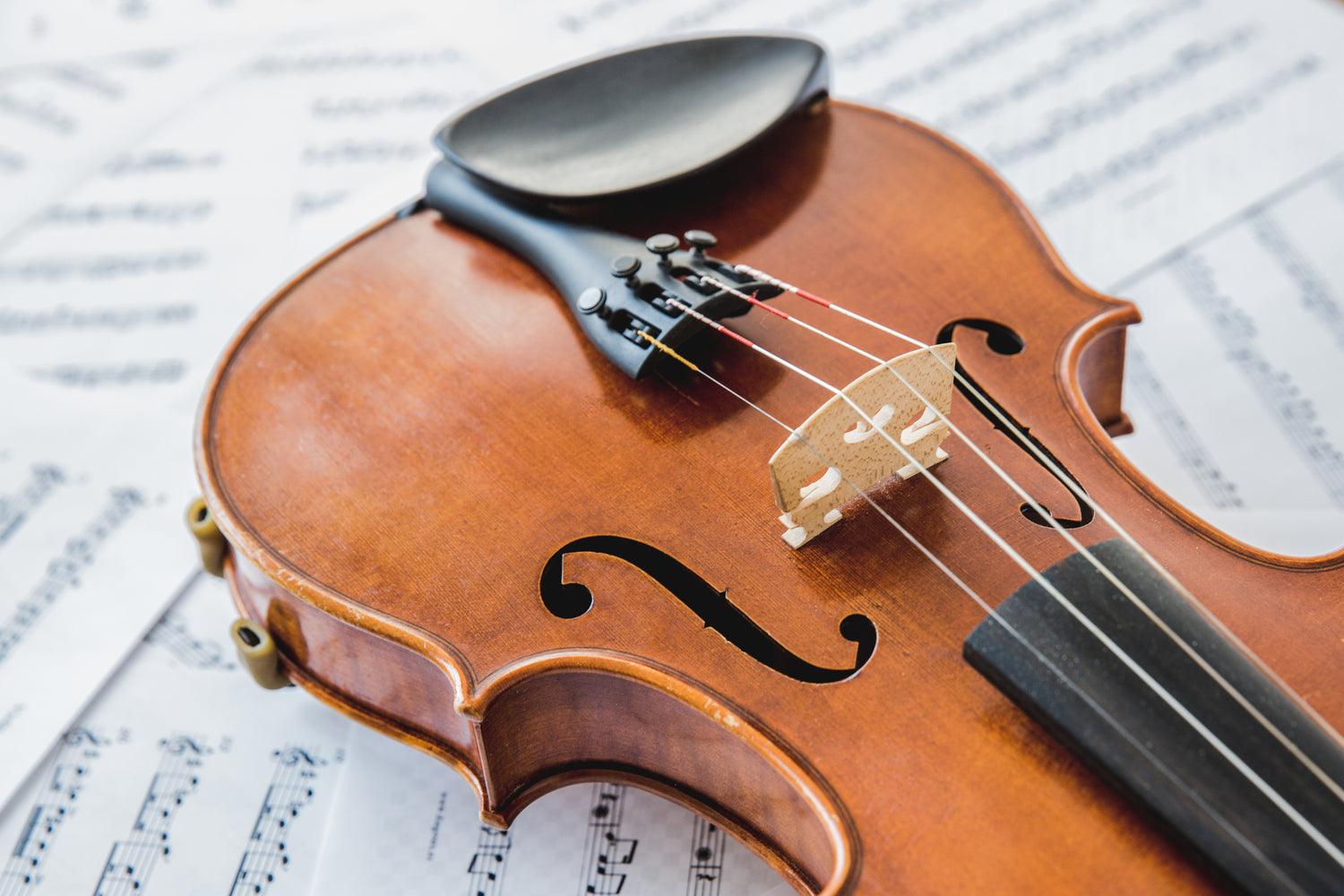 a stock photo of a violin and sheet music